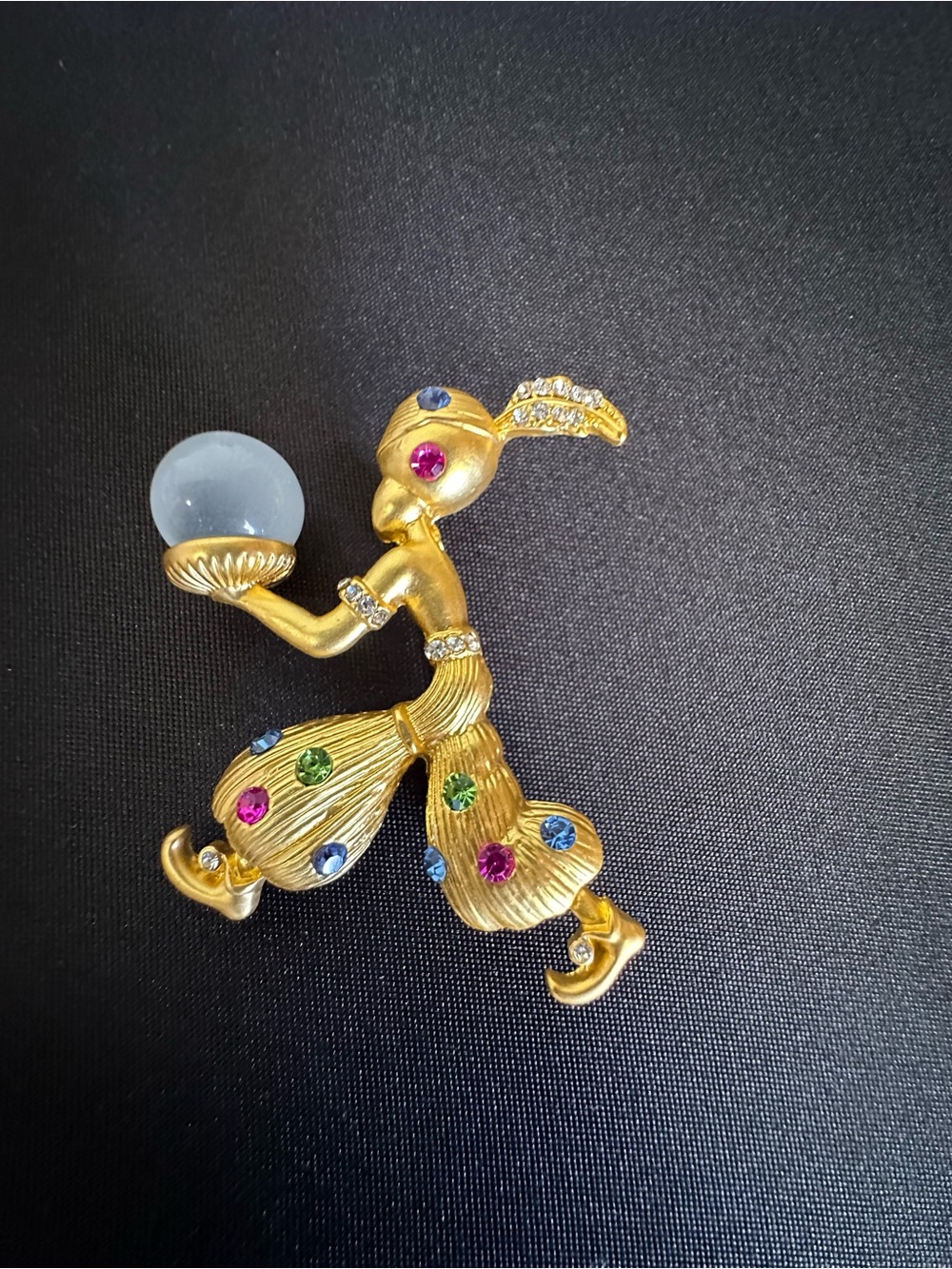 Genie fortune teller With multi-colored rhinestones and a crystal ball brooch